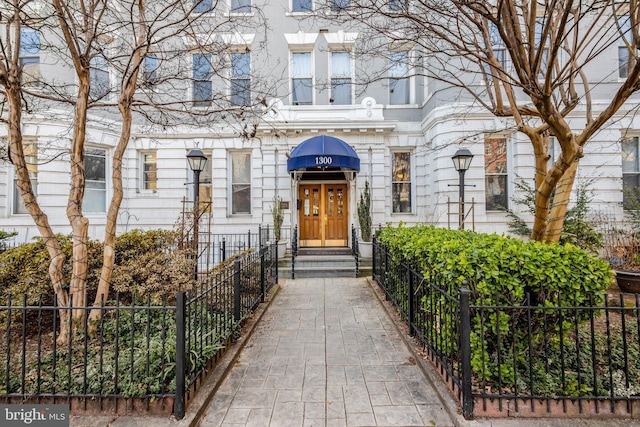 doorway to property featuring fence