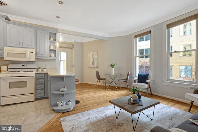 kitchen featuring a peninsula, white appliances, gray cabinets, and open shelves