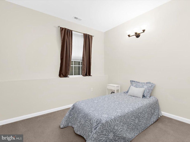 carpeted bedroom with visible vents and baseboards