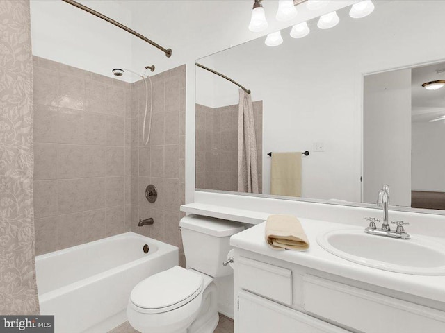 full bath with shower / tub combo, vanity, and toilet