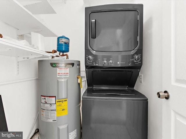 washroom with laundry area, stacked washing maching and dryer, and electric water heater