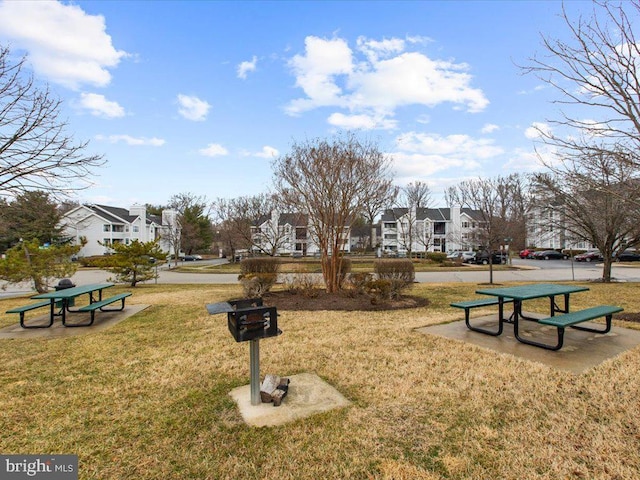 view of home's community featuring a residential view and a yard