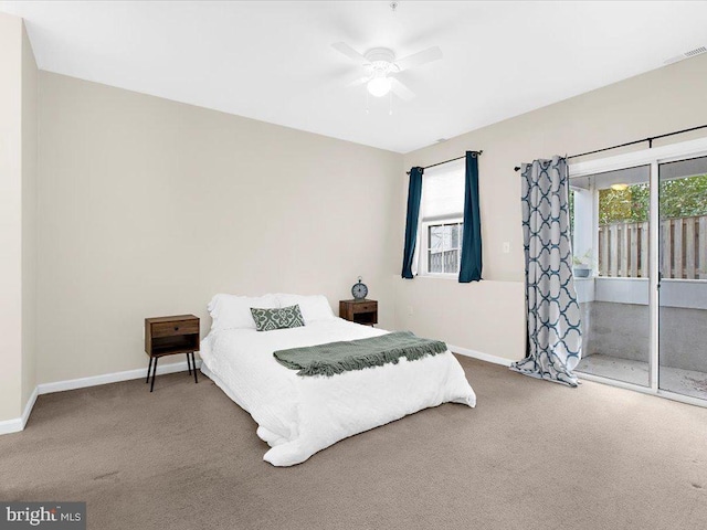 bedroom with carpet floors, multiple windows, and access to exterior