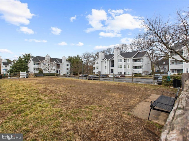 view of community with a residential view and a yard