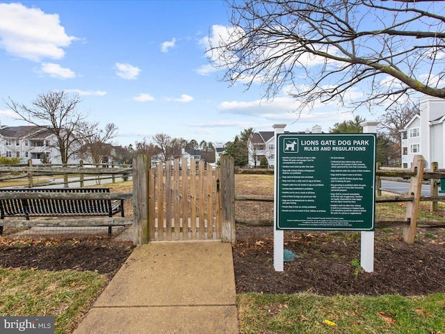 view of home's community with a gate, fence, and a residential view