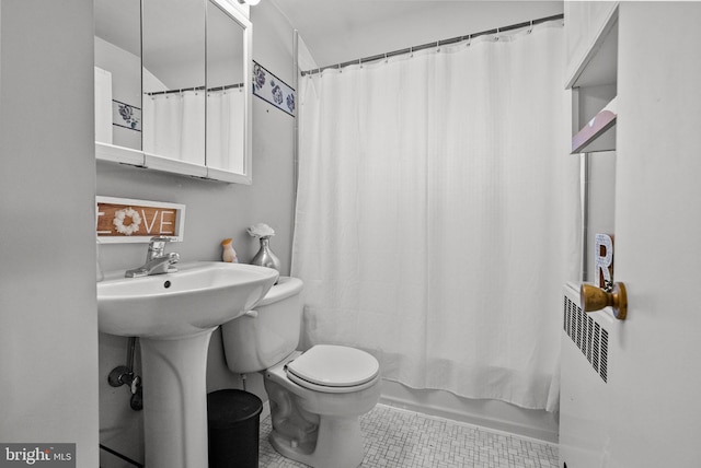 bathroom featuring toilet, shower / bath combo, and tile patterned floors