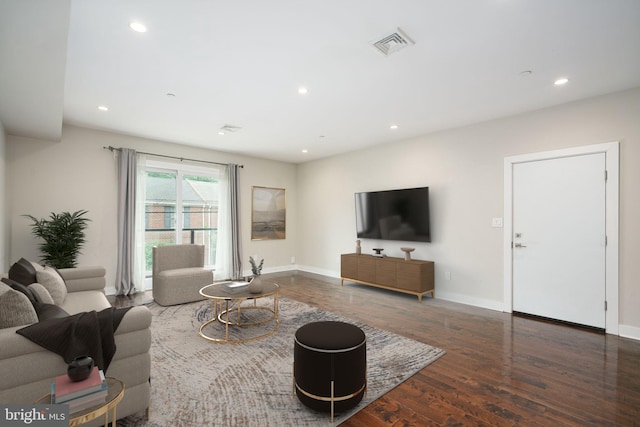 living area with baseboards, visible vents, wood finished floors, and recessed lighting