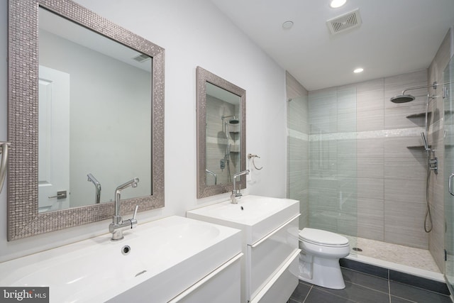 full bath featuring visible vents, toilet, tile patterned floors, a shower stall, and a sink