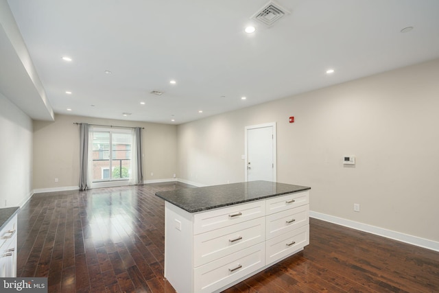 kitchen with baseboards, visible vents, and dark wood-style flooring