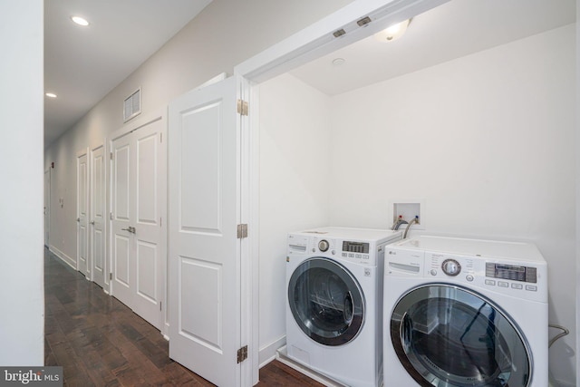 laundry area with dark wood finished floors, washer and clothes dryer, recessed lighting, visible vents, and laundry area