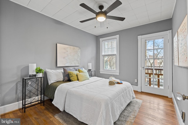 bedroom featuring baseboards, ceiling fan, and hardwood / wood-style floors