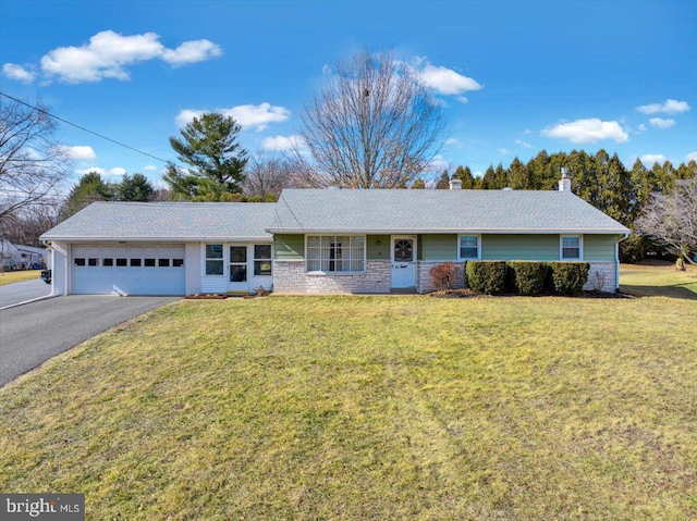 ranch-style home with a garage, driveway, a chimney, and a front yard