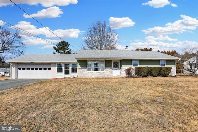 ranch-style house with aphalt driveway, a chimney, a garage, stone siding, and a front lawn