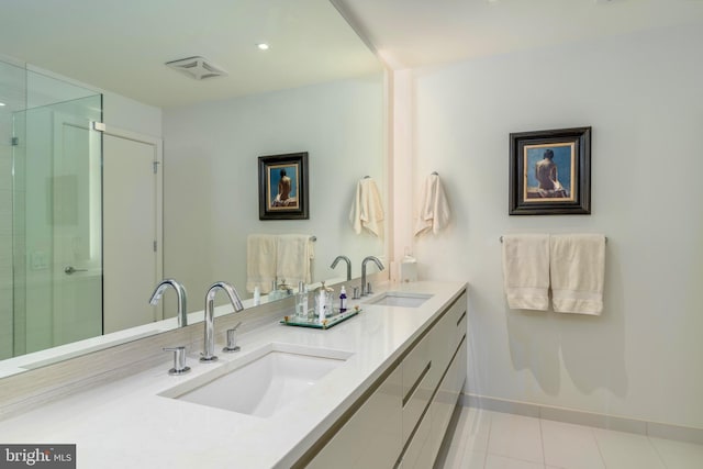 bathroom featuring a shower stall, visible vents, and a sink