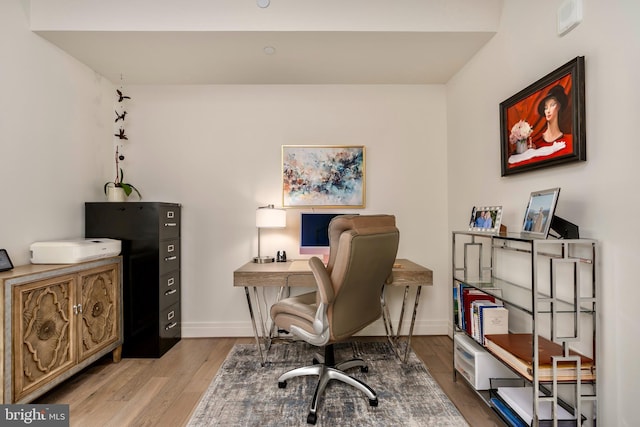 home office featuring baseboards and wood finished floors