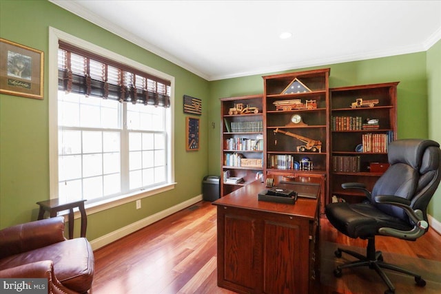 home office with ornamental molding, wood finished floors, and baseboards