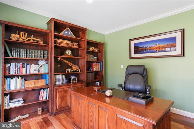 office area featuring ornamental molding, wood finished floors, and baseboards