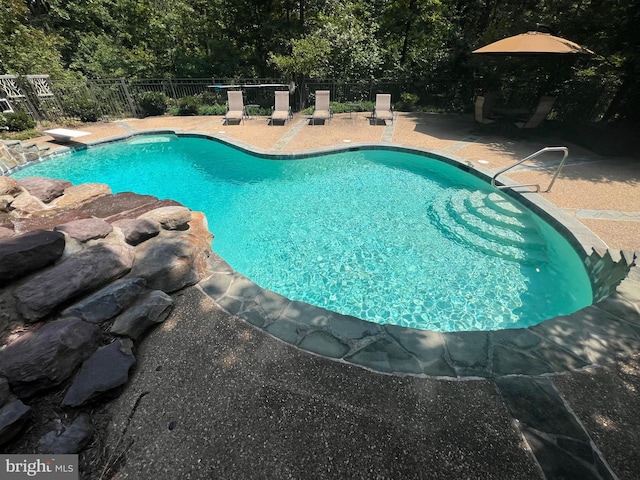 view of pool featuring a patio area, fence, and a fenced in pool