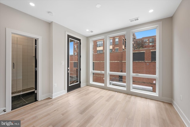 spare room featuring recessed lighting, baseboards, visible vents, and light wood finished floors