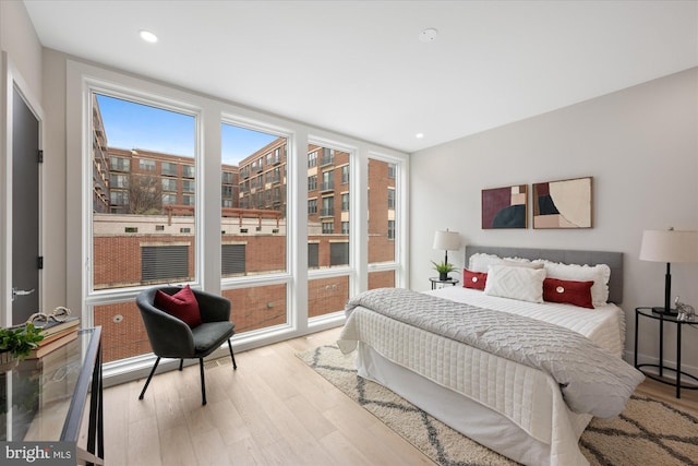 bedroom with recessed lighting and wood finished floors