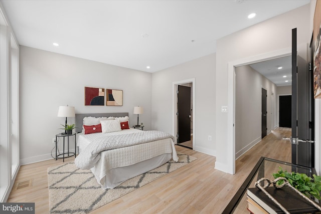 bedroom with recessed lighting, light wood-style flooring, and visible vents