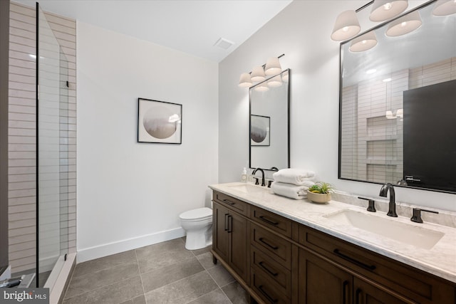 bathroom with visible vents, toilet, baseboards, and a sink