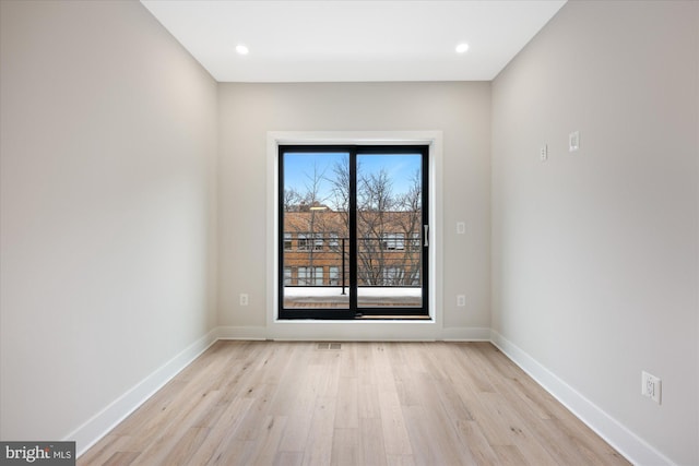 empty room featuring recessed lighting, light wood-style floors, and baseboards