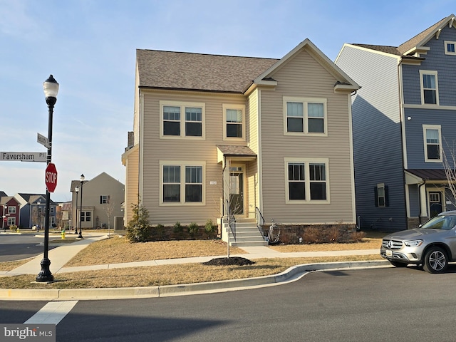 view of property featuring a residential view and roof with shingles