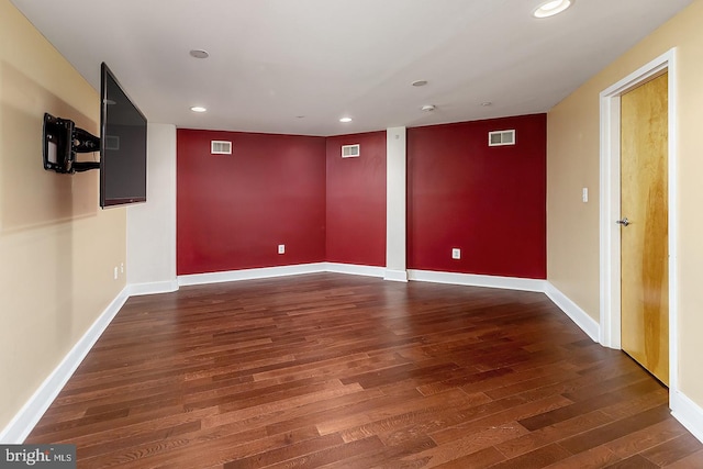 spare room featuring baseboards, wood finished floors, visible vents, and recessed lighting