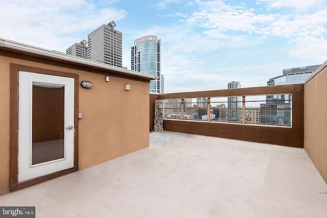 view of patio featuring a view of city and a balcony