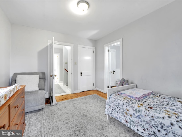 bedroom featuring wood finished floors and baseboards