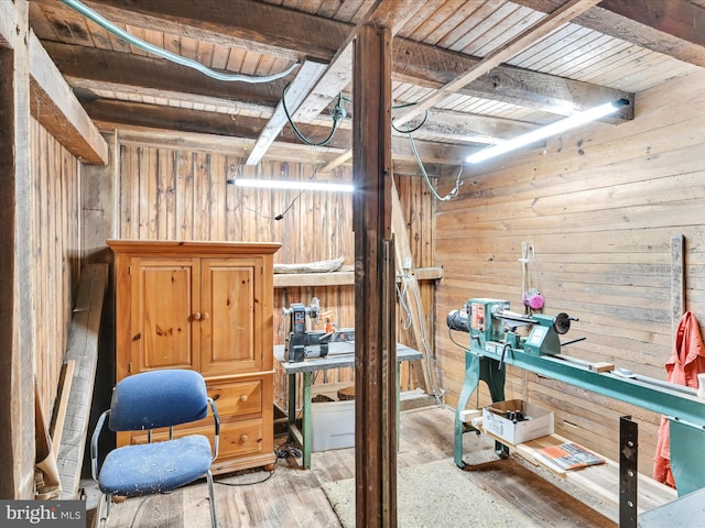 basement featuring wooden ceiling, wooden walls, and wood finished floors