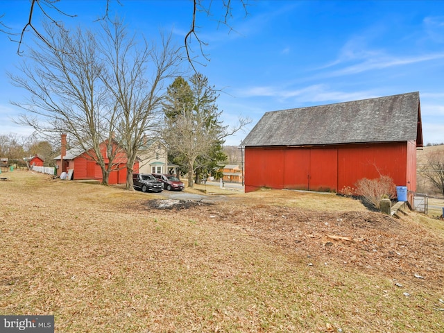 view of yard featuring a barn and an outdoor structure