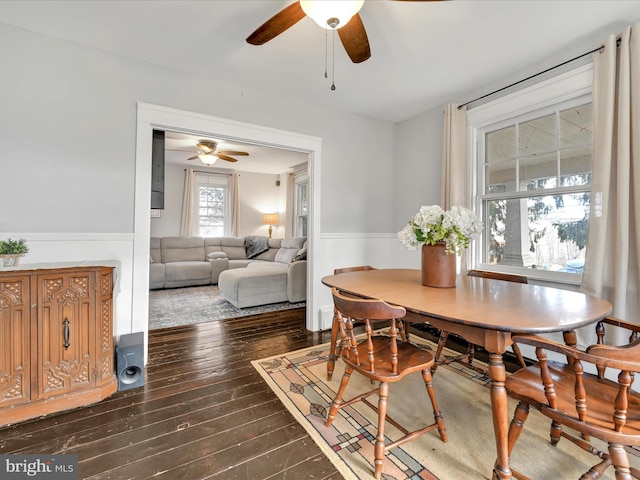 dining area with dark wood finished floors and a ceiling fan