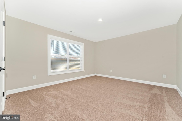 carpeted spare room with baseboards