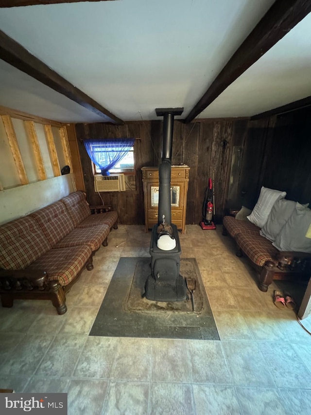 living area featuring a wood stove, wooden walls, cooling unit, and beam ceiling