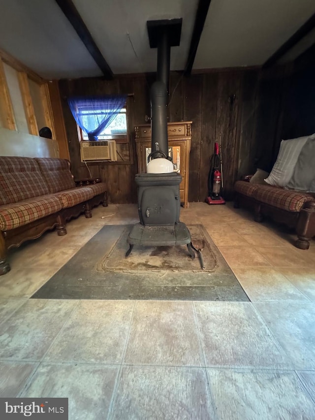 room details featuring a wood stove, wooden walls, cooling unit, and beamed ceiling