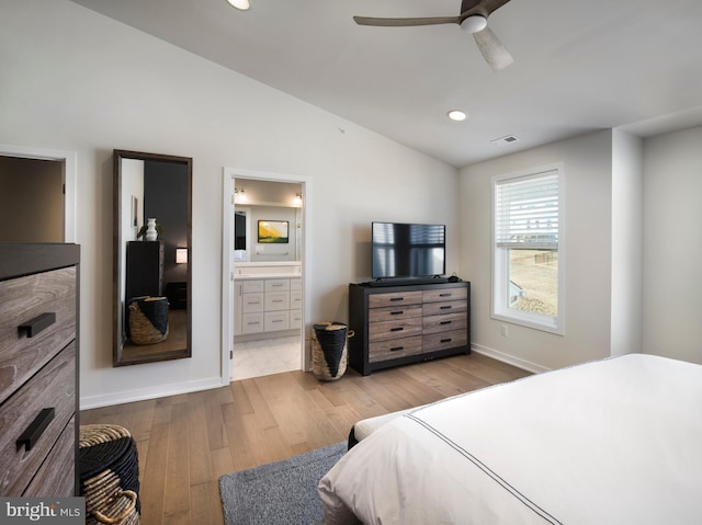 bedroom with visible vents, lofted ceiling, recessed lighting, hardwood / wood-style flooring, and connected bathroom