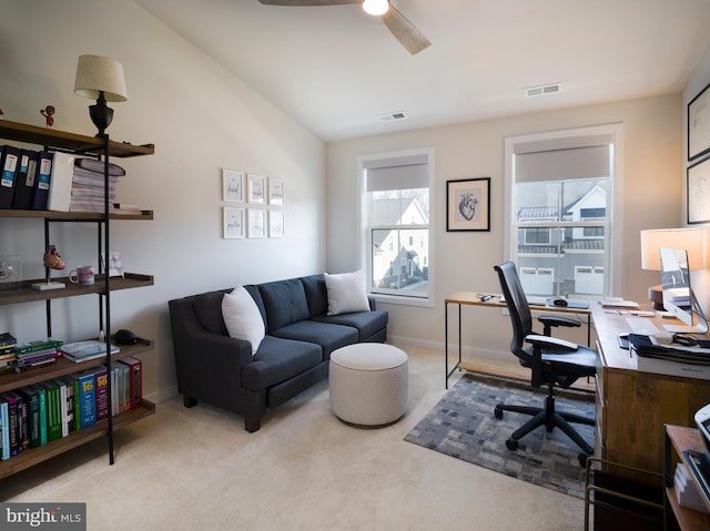 carpeted office space with visible vents, baseboards, and ceiling fan