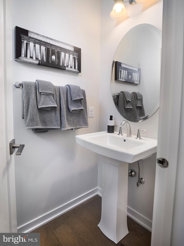 bathroom with wood finished floors and baseboards