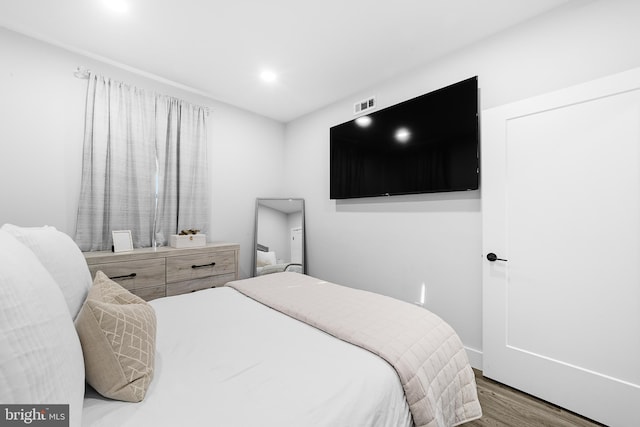 bedroom with wood finished floors, visible vents, and recessed lighting