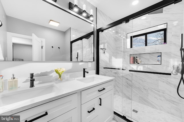 full bathroom featuring marble finish floor, a sink, a marble finish shower, and double vanity