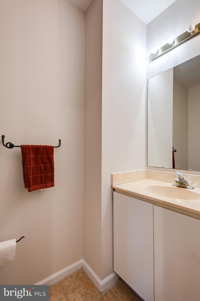 bathroom with vanity, baseboards, and tile patterned floors