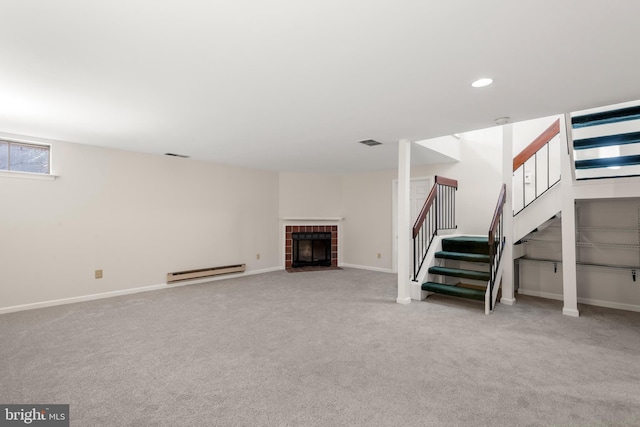 basement featuring stairs, a baseboard radiator, visible vents, and carpet