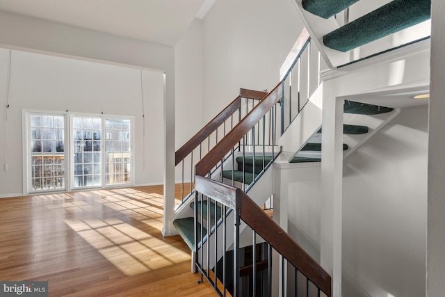 stairs featuring baseboards and wood finished floors