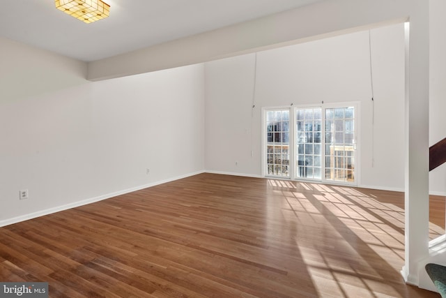 empty room with wood finished floors and baseboards