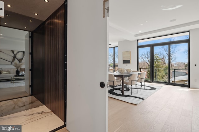 hallway featuring wood finished floors and recessed lighting