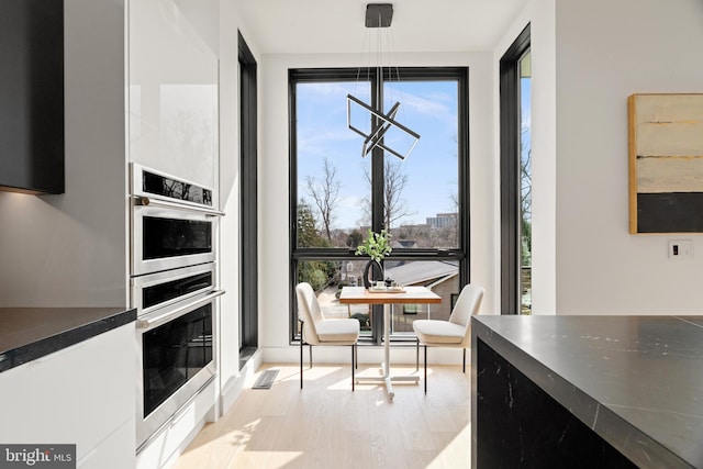 dining room with light wood-type flooring and visible vents