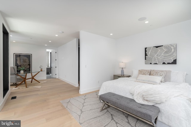 bedroom featuring baseboards, wood finished floors, visible vents, and recessed lighting