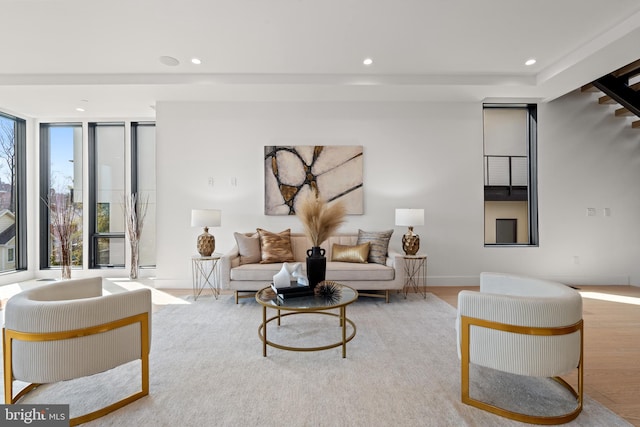 living area with recessed lighting, baseboards, expansive windows, and wood finished floors